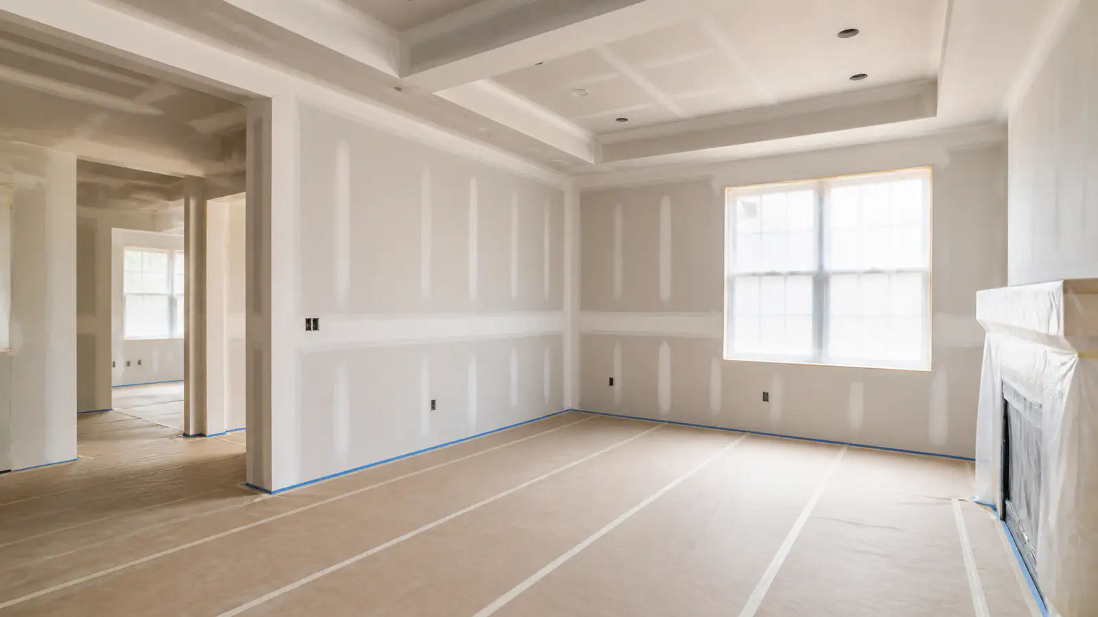 Taped drywall seams in a carefully protected room