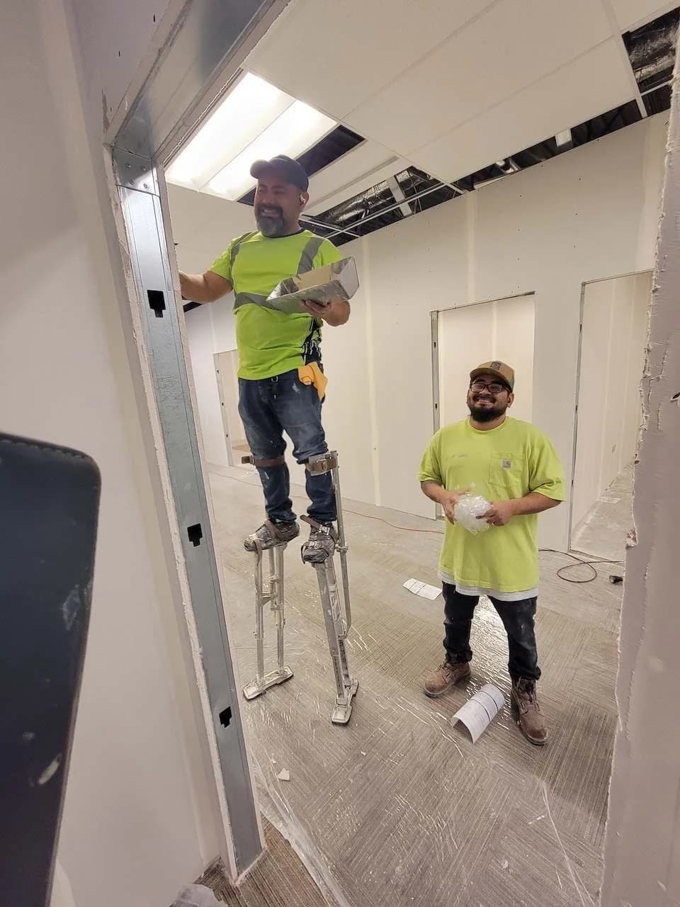 Solis crew members working inside a commercial interior under construction